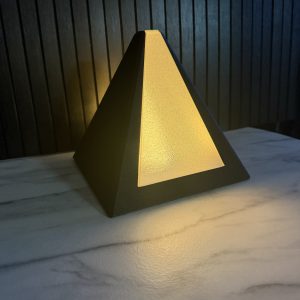 3D printed Ramses pyramid lamp glowing, black textured frame
